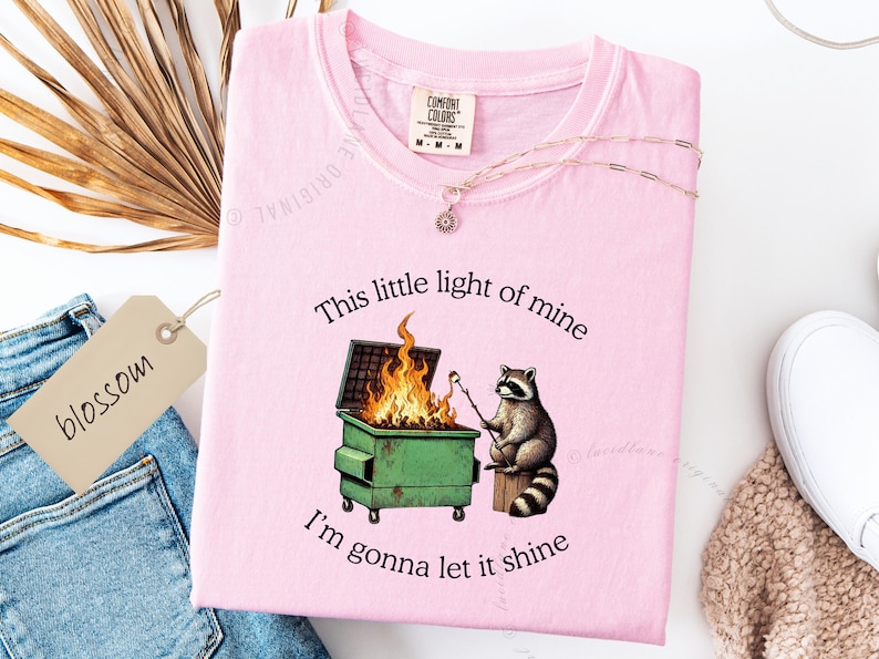 funny dumpster fire shirt, dumpster fire raccoon shirt, raccoon dumpster fire meme tee, trash panda shirt, funny raccoon graphic tee, this little light of mine parody shirt, chaotic raccoon shirt, anxiety humor shirt, funny meme t shirt, roasting marshmallow raccoon tee, comfort colors funny shirt, ironic humor tee, relatable humor shirt, chaos meme shirt, funny animal meme shirt, satirical graphic tee, unhinged raccoon tee, funny gift shirt, mental health meme tee, sarcastic tee, viral shirt