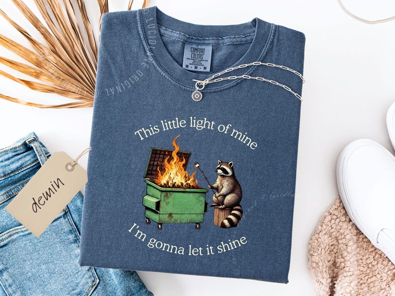 funny dumpster fire shirt, dumpster fire raccoon shirt, raccoon dumpster fire meme tee, trash panda shirt, funny raccoon graphic tee, this little light of mine parody shirt, chaotic raccoon shirt, anxiety humor shirt, funny meme t shirt, roasting marshmallow raccoon tee, comfort colors funny shirt, ironic humor tee, relatable humor shirt, chaos meme shirt, funny animal meme shirt, satirical graphic tee, unhinged raccoon tee, funny gift shirt, mental health meme tee, sarcastic tee, viral shirt