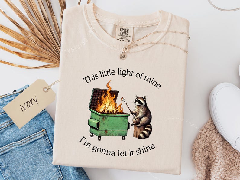 funny dumpster fire shirt, dumpster fire raccoon shirt, raccoon dumpster fire meme tee, trash panda shirt, funny raccoon graphic tee, this little light of mine parody shirt, chaotic raccoon shirt, anxiety humor shirt, funny meme t shirt, roasting marshmallow raccoon tee, comfort colors funny shirt, ironic humor tee, relatable humor shirt, chaos meme shirt, funny animal meme shirt, satirical graphic tee, unhinged raccoon tee, funny gift shirt, mental health meme tee, sarcastic tee, viral shirt