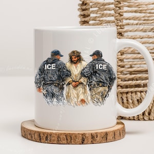 May include: White ceramic mug featuring a graphic of Jesus flanked by two figures in black jackets with "ICE" on the back. The artwork is set against a neutral background, with a wooden coaster beneath the mug.