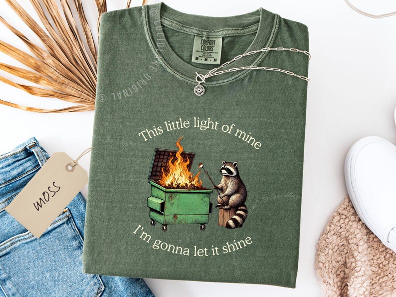 funny dumpster fire shirt, dumpster fire raccoon shirt, raccoon dumpster fire meme tee, trash panda shirt, funny raccoon graphic tee, this little light of mine parody shirt, chaotic raccoon shirt, anxiety humor shirt, funny meme t shirt, roasting marshmallow raccoon tee, comfort colors funny shirt, ironic humor tee, relatable humor shirt, chaos meme shirt, funny animal meme shirt, satirical graphic tee, unhinged raccoon tee, funny gift shirt, mental health meme tee, sarcastic tee, viral shirt