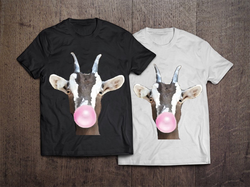 May include: Two t-shirts with a graphic of a goat with a pink bubble of gum in its mouth. One t-shirt is black and the other is white.