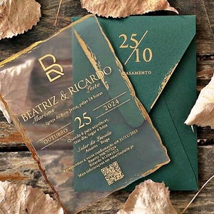 May include: A clear acrylic wedding invitation with gold-painted edges and gold text featuring the names Beatriz and Ricardo, the date 25 October 2024, and a QR code, placed over a dark green envelope with the date 25/10 printed in gold.