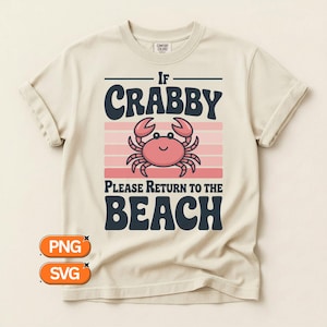 May include: Cream-colored t-shirt with the text "If Crabby Please Return to the Beach" above a pink crab illustration. The design includes pink and white horizontal stripes. The shirt has rolled-up sleeves.