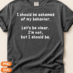 Può includere: Una t-shirt a maniche corte color grigio antracite con testo bianco che recita: I should be ashamed of my behavior. Let's be clear. I'm not, but I should be. La maglia presenta un girocollo e un'etichetta del marchio Comfort Colors sul colletto.