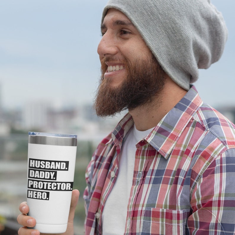May include: White stainless steel tumbler with black text that reads "Husband. Daddy. Protector. Hero."