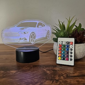 May include: A 3D printed night light shaped like a car with a remote control for changing the colour of the light. The remote has 16 different colour options.