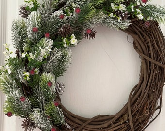 Christmas Wreath. Greenery flocked wreath. Pine with pincones winter wreath