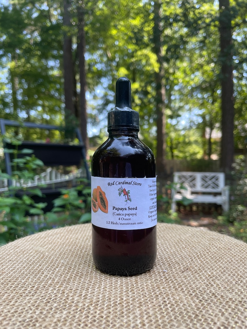 May include: A 4 ounce bottle of Papaya Seed tincture in a dark glass bottle with a dropper. The bottle has a label that says "Red Cardinal Store" and "Papaya Seed (Carica papaya)". The label also says "1:2 Herb/menstruum ratio".
