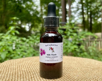 May include: A brown glass bottle with a black dropper top, labeled "Red Cardinal Store" and "Milk Thistle (Silybum marianum)". The bottle contains 1 ounce of milk thistle extract and has a 1:2 herb/menstruum ratio.