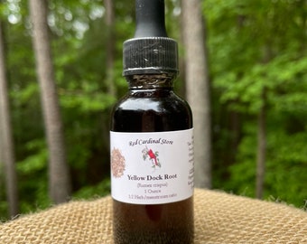 May include: A glass bottle with a dropper top filled with a dark liquid. The label reads "Red Cardinal Store Yellow Dock Root (Rumex crispus) 1 Ounce 1:2 Herb/menstruum ratio".