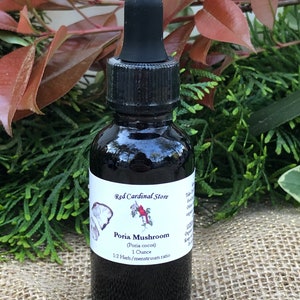 May include: A dark glass bottle with a dropper top, labeled "Red Cardinal Store" and "Poria Mushroom (Poria cocos) 1 Ounce 1:2 Herb/menstruum ratio".