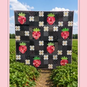 May include: A quilt pattern titled Strawberry Patch, Pattern No. 044, featuring a 72 inch by 72 inch quilt design. The quilt displays a repeating pattern of red strawberries with green tops and white flowers set against a dark gray background.