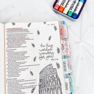 May include: A black and white illustration of a building with a quote from the Bible, "He has worked wonders for you." The quote is from Joel 2:26. The illustration is surrounded by colorful tabs with the names of different books of the Bible, including Micah, Amos, Obadiah, Jonah, and Joel.