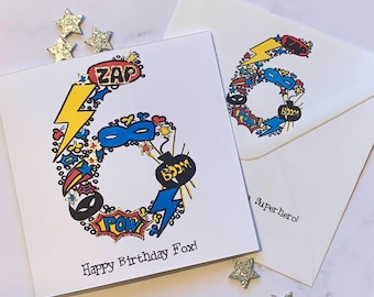 Superhero personalised 6th  birthday card . Cartoon style watercolour illustration of the number 6 embellished with silver metallic detail.