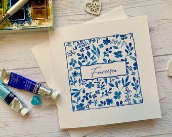 Named Birthday card . Striking blue and white watercolour border surrounding recipients name. Embellished with delicate gems.