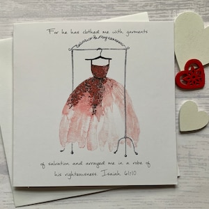 May include: A watercolour illustration of a dress on a hanger with the text "For he has clothed me with garments of salvation and arrayed me in a robe of his righteousness. Isaiah 61:10".