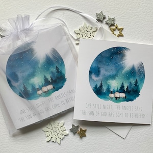 Christian Christmas cards. Beautiful watercolour sheep in a winter scene embellished with foiled dots with a wonderful Christian message