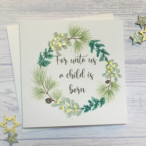 May include: A white card with a green watercolor wreath and the text "For unto us a child is born".