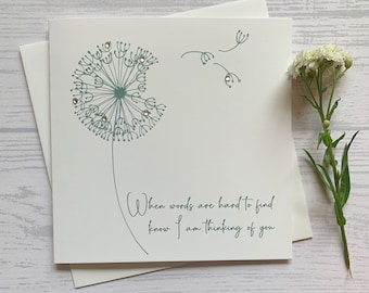 May include: A white card with a green dandelion illustration and the text "When words are hard to find know I am thinking of you".