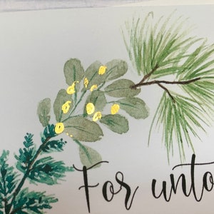 May include: A watercolor painting of a green pine branch with gold accents. The text "For unto" is written in black ink below the branch.