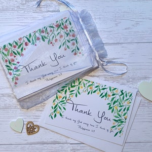 May include: Set of two thank you cards with floral designs and the text "Thank You" and "I thank my God every time I think of you. Philippians 1:3".