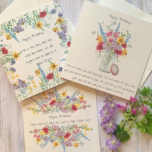 May include: Greeting cards with floral designs and the text "Happy Birthday!" are displayed. One card features a floral border with a Bible verse. Another card shows a bouquet in a jar. The third card has a floral arrangement.