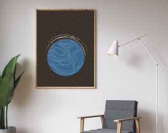 May include: A framed print of a blue planet with white lines on a dark background with white stars. The print is hanging on a white wall above a gray armchair with wooden legs.
