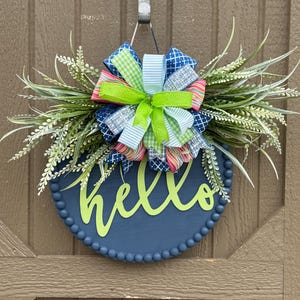 Percha de puerta azul costero con texto &quot;Hola&quot;