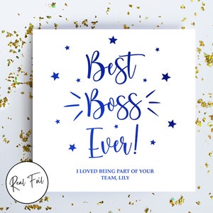 May include: A square white greeting card featuring the blue text "Best Boss Ever!" in a script font, surrounded by small blue stars. Below the main text, the card reads "I LOVED BEING PART OF YOUR TEAM, LILY" in blue capital letters. A circular badge reads "Real Foil".