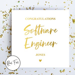 May include: A white card with gold foil lettering saying "CONGRATULATIONS Software Engineer JONES" and a heart symbol. The card is surrounded by gold confetti. A circular sticker in the bottom left corner reads "Real Foil".
