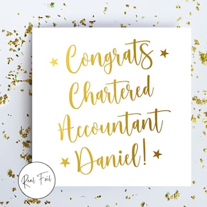 May include: A white card with gold foil lettering that reads "Congrats Chartered Accountant Daniel!" with star accents. The card is surrounded by gold confetti, and a "Real Foil" logo is in the bottom left corner.