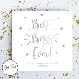 May include: A square white greeting card featuring silver foil text that reads Best Boss Ever! and I LOVED BEING PART OF YOUR TEAM, LILY. The card is decorated with silver foil stars and is surrounded by scattered gold confetti on a white surface.