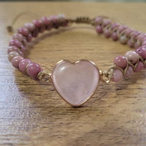 Stunning Rhodonite Heart Bracelet entwined in string braid. Healing Crystals Chakra Bracelet for Meditation and Yoga.