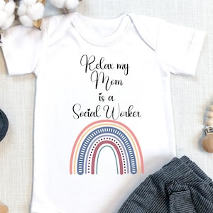 May include: White baby onesie with the text "Relax my Mom is a Social Worker" and a rainbow graphic.