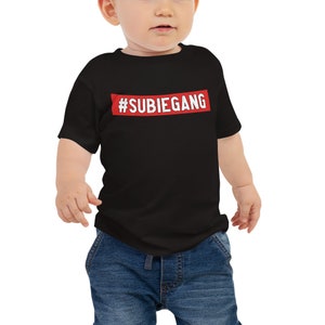 May include: A black baby t-shirt with a red rectangle that says "#SUBIEGANG" in white text.
