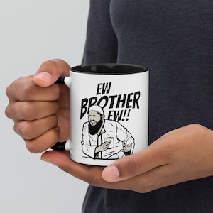 May include: White ceramic mug with a black rim and handle. The mug features a cartoon illustration of a man with a beard and a hat, with the text "EW BROTHER EW!" printed in black.