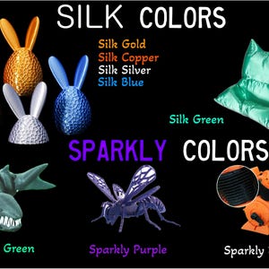 May include: Image showcasing various objects in "Silk Colors" and "Sparkly Colors." Includes bunny-shaped objects in gold, copper, silver, and blue. Also features a green pillow, a green shark, a purple insect, and an orange object. Text on the image reads "SILK COLORS" and "SPARKLY COLORS."
