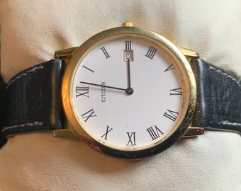 Montre à quartz Citizen vintage pour homme avec boîtier fin doré