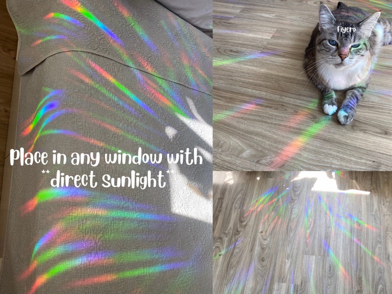 May include: A rainbow prism window cling creates colorful light patterns on a wooden floor and a white fabric surface. The text "Place in any window with direct sunlight" is visible in the image.
