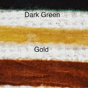 May include: Three velvet ribbons in different shades of green and gold. The top ribbon is dark green, the middle ribbon is gold, and the bottom ribbon is dark gold.