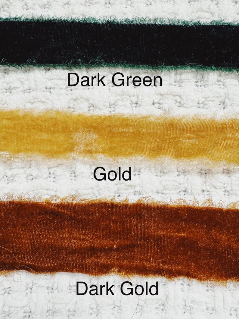 May include: Three velvet ribbons in different shades of green and gold. The top ribbon is dark green, the middle ribbon is gold, and the bottom ribbon is dark gold.