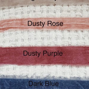 May include: Four fabric swatches in different colors: light gray, dusty rose, dusty purple, and dark blue. The swatches are arranged vertically on a white textured surface.