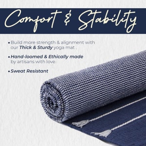May include: A rolled up navy blue and white striped yoga mat with tassels. The mat is thick and sturdy, hand-loomed and ethically made. The text "Comfort & Stability" is at the top of the image. The text "Build more strength & alignment with our Thick & Sturdy yoga mat." is below the title. The text "Hand-loomed & Ethically made by artisans with love." is below that. The text "Sweat Resistant" is at the bottom of the image.