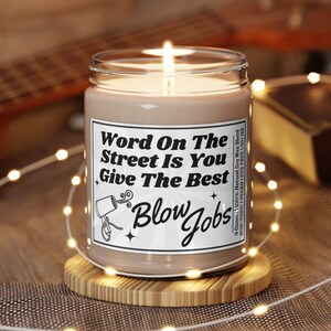 Soy Vegan Candle in Reusable Glass Jar with Black Lid. Detailed Label says "Word on the street is you give the best blow jobs" with a picture of a hairdryer