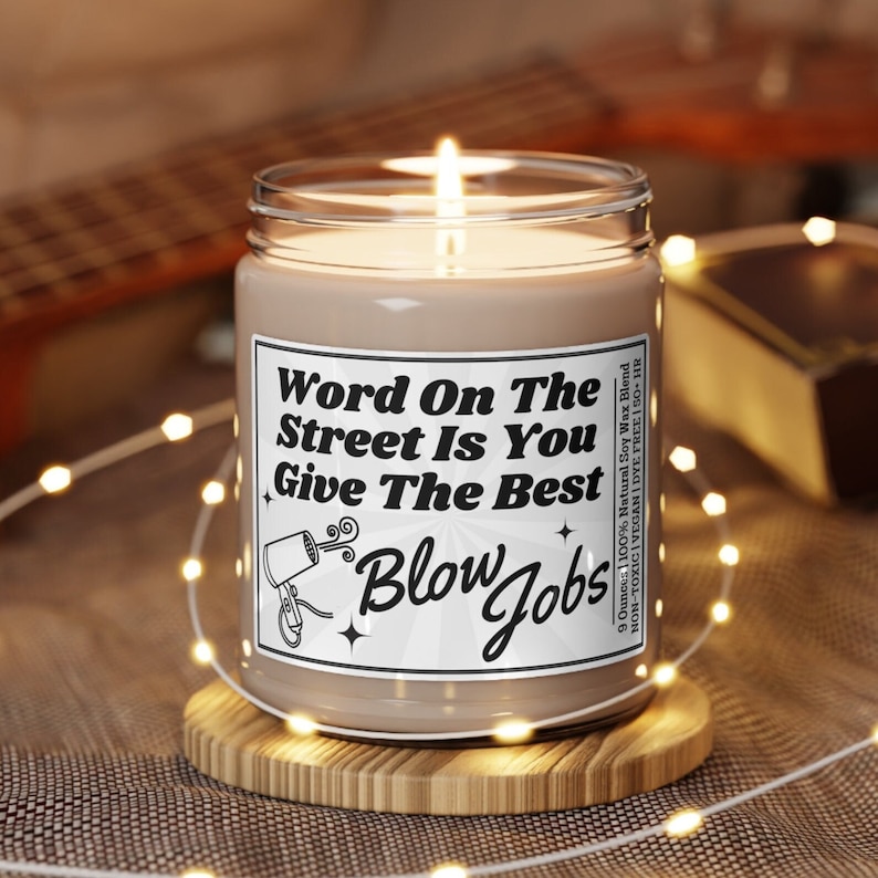 Soy Vegan Candle in Reusable Glass Jar with Black Lid. Detailed Label says "Word on the street is you give the best blow jobs" with a picture of a hairdryer