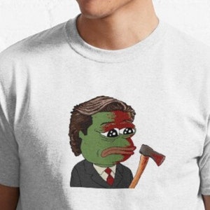 Puede incluir: Una rana de dibujos animados verde con una cara roja y blanca que lleva un traje oscuro y sostiene un hacha. La rana tiene una expresión triste y mira hacia la izquierda.