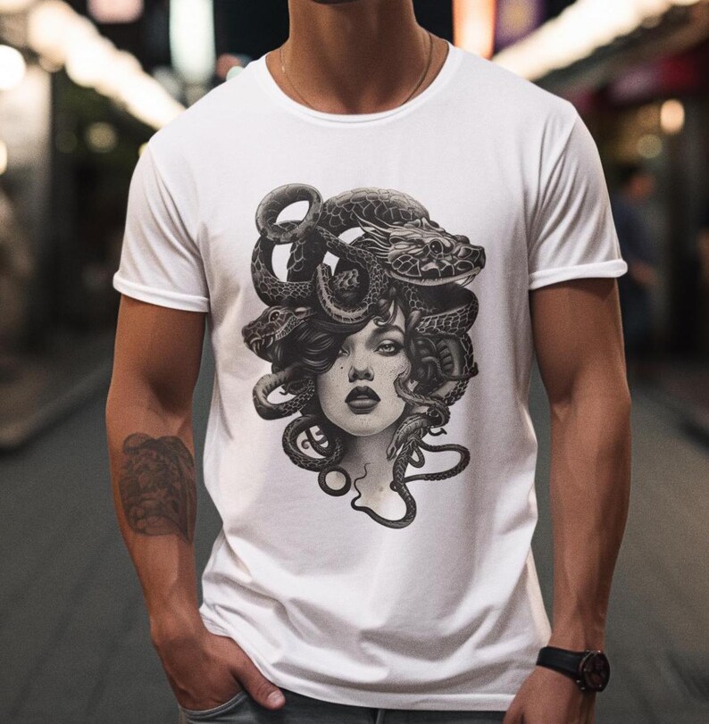 May include: White t-shirt with a black and white graphic print of Medusa, a mythical Greek figure with snakes for hair.