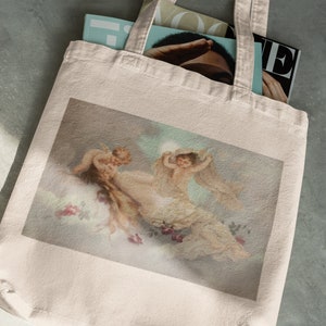 May include: A white canvas tote bag with a printed image of three cherubs in a cloudy sky. The cherubs are depicted in a soft, pastel color palette.