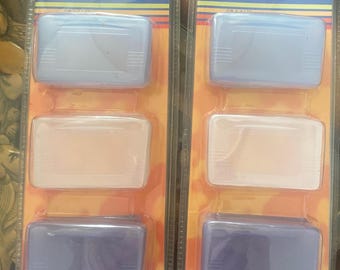 May include: Two identical retail packages of Yobo Gameware Game Cases, each containing three rectangular plastic protective cases in light blue, clear, and dark blue. The packaging features a blue header with the text Game Case and orange backing.